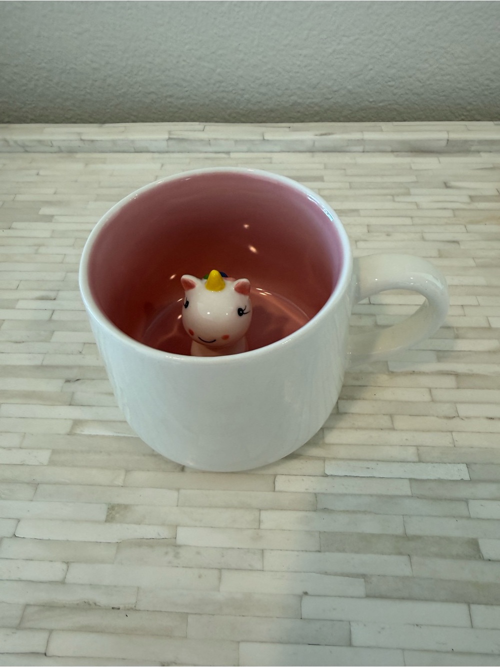 White Ceramic Mug with Pink Interior and Unicorn Figurine